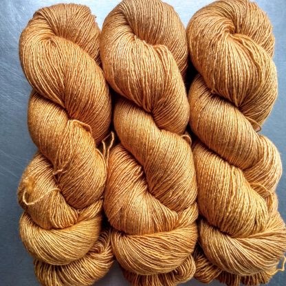 Anemone - Light orange with a yellow undertone Falklands Merino and silk blend yarn. Hand-dyed by Triskelion Yarn.