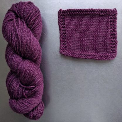 Helleborine - Dark Tyrian red-purple Bluefaced Leicester worsted weight yarn hand-dyed by Triskelion Yarn