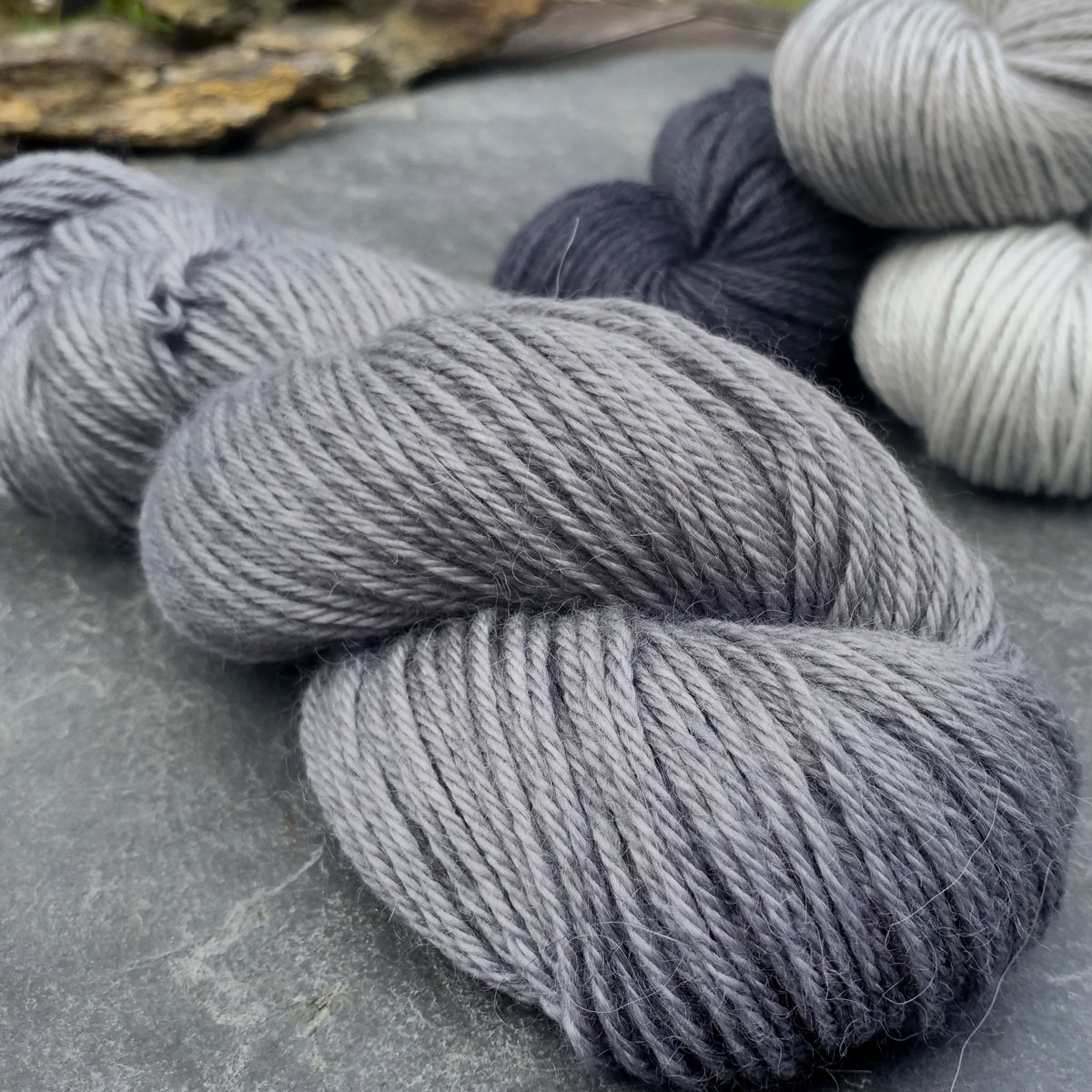 Graphite - Cool, mid-toned grey baby alpaca double knit (DK) yarn. Hand-dyed by Triskelion Yarn