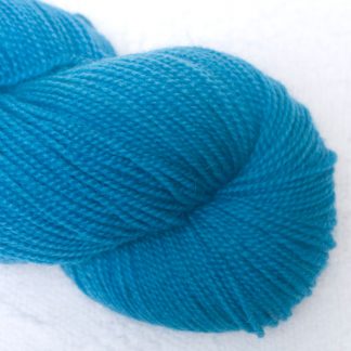 Wade - Mid-tone bright azure blue Corriedale 4-ply/fingering weight yarn. Hand-dyed by Triskelion Studio.