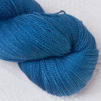 Offing - Mid-toned indigo blue Merino and silk blend lace weight yarn. Hand-dyed by Triskelion Yarn.