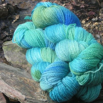Riverbed - Variegated, ranging from sapphire to turquoise to emerald Bluefaced Leicester sport weight yarn hand-dyed by Triskelion Yarns