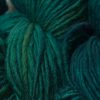 Mid to dark teal green Corriedale thick and thin slub yarn. Hand-dyed by Triskelion Yarn.