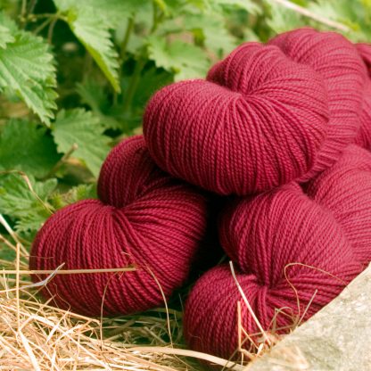 Carnation - Deep rose red GOTS standard organic machine-washable Merino 4-ply / fingering weight yarn. Hand-dyed by Triskelion Yarn