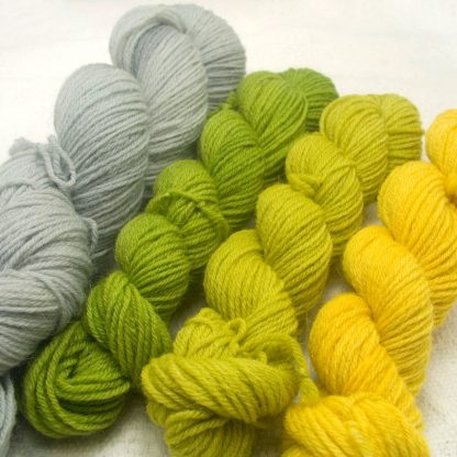 Scythe: Spring green, grey and yellow 4-ply/fingering Peruvian Highland wool sock yarn. Hand-dyed by Triskelion Yarn.